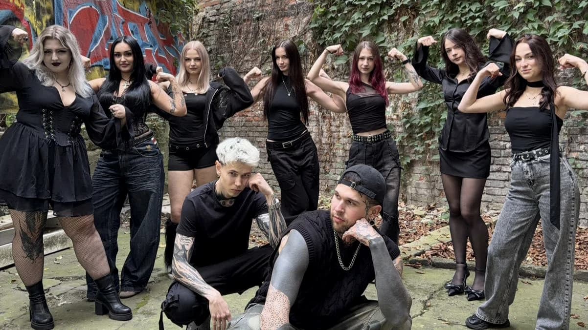 The DEEPCUT crew in a graffiti courtyard — barbers, tattoo artists and nail artists