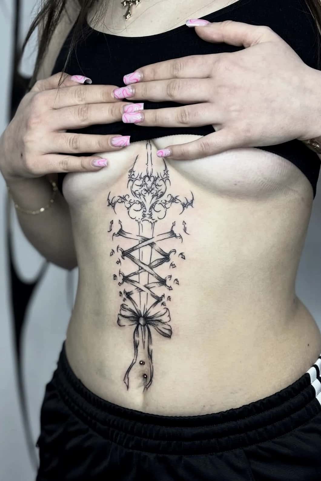 Corset lacing with a bow and an ornament down the sternum